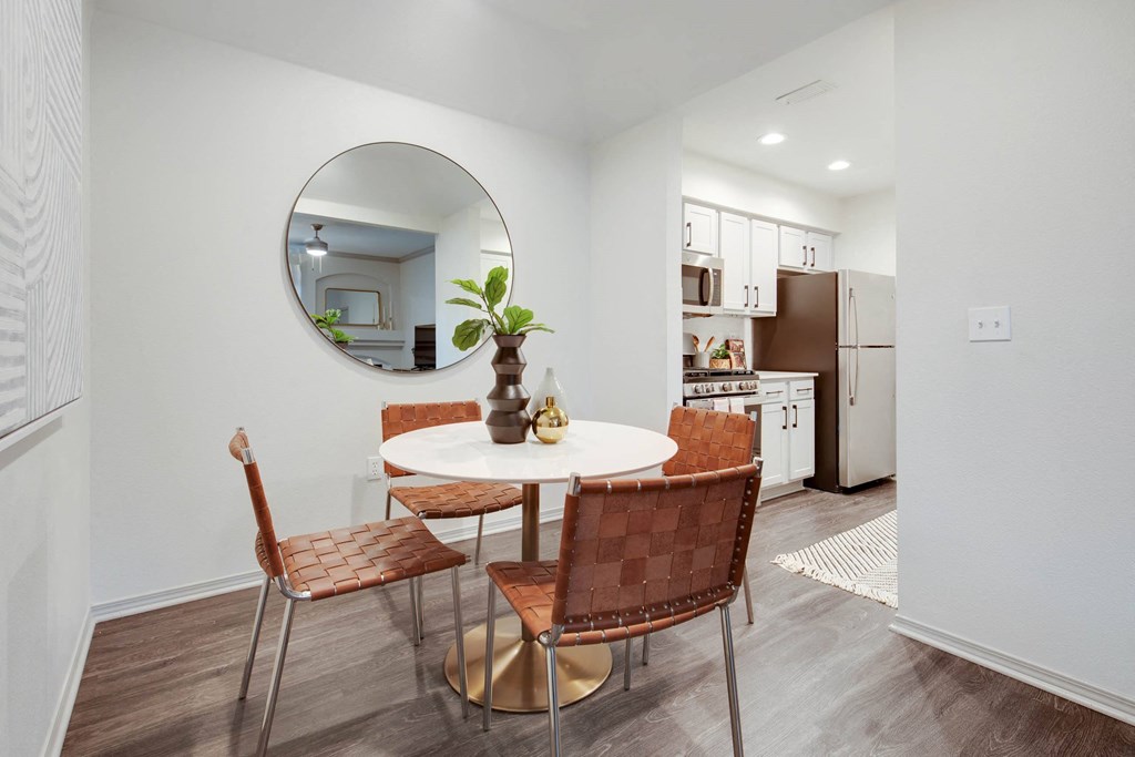 a living room with a table and a mirror in it at The Olivine, Texas, 78727